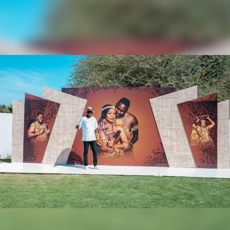 Large African-print event backdrop with a couple outdoors