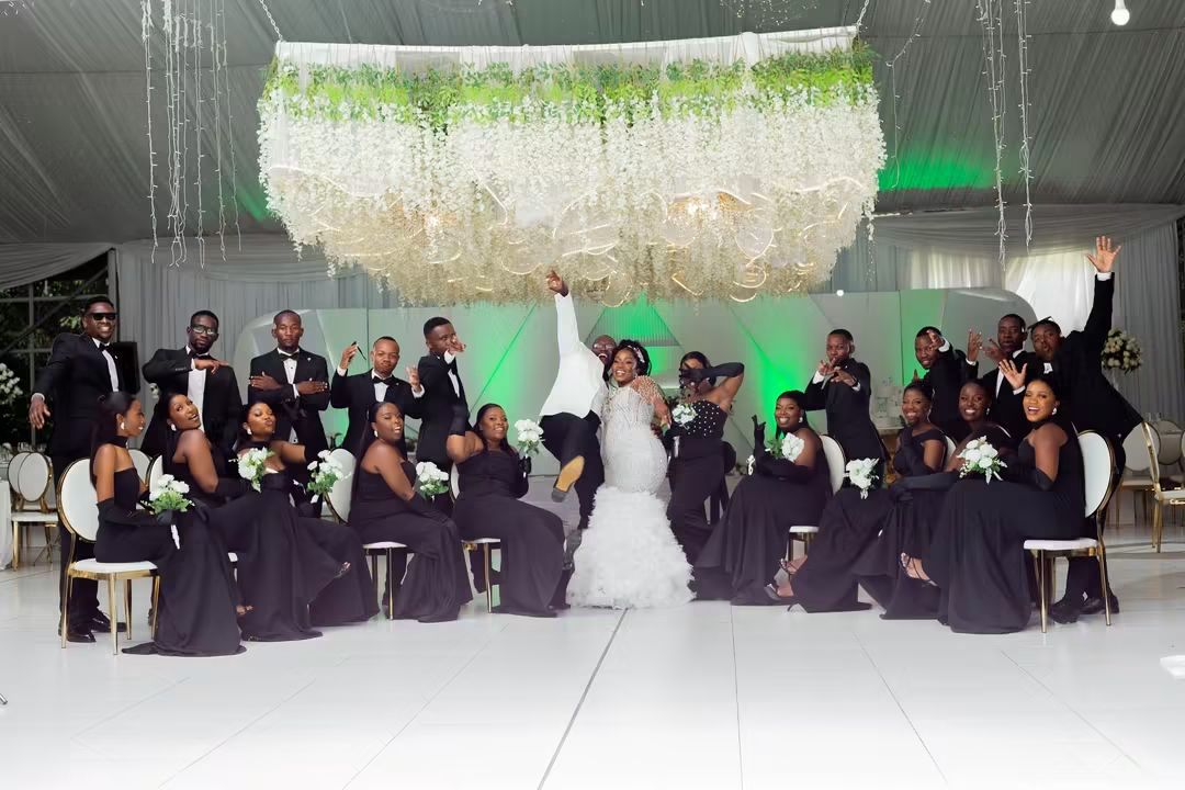 Bridal party celebrating with the bride and groom on the dance floor