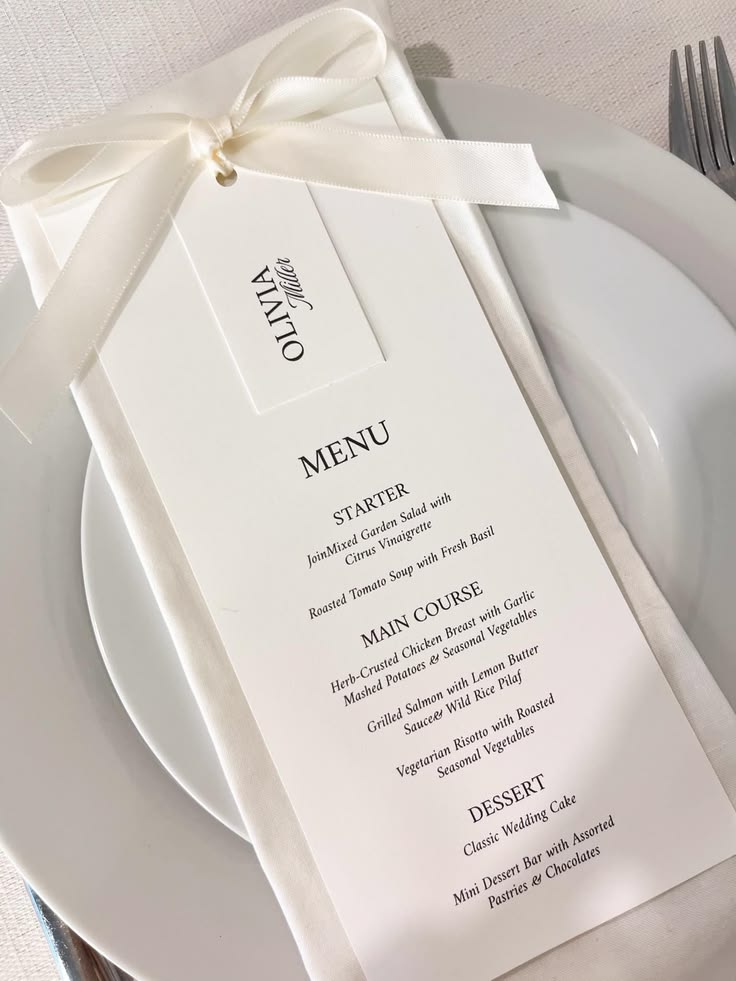 White wedding menu and place card tied with an ivory ribbon