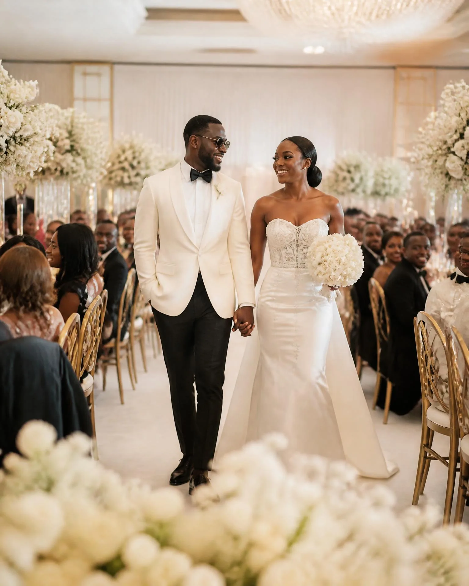 Ceremony aisle styled with white florals and draped seating