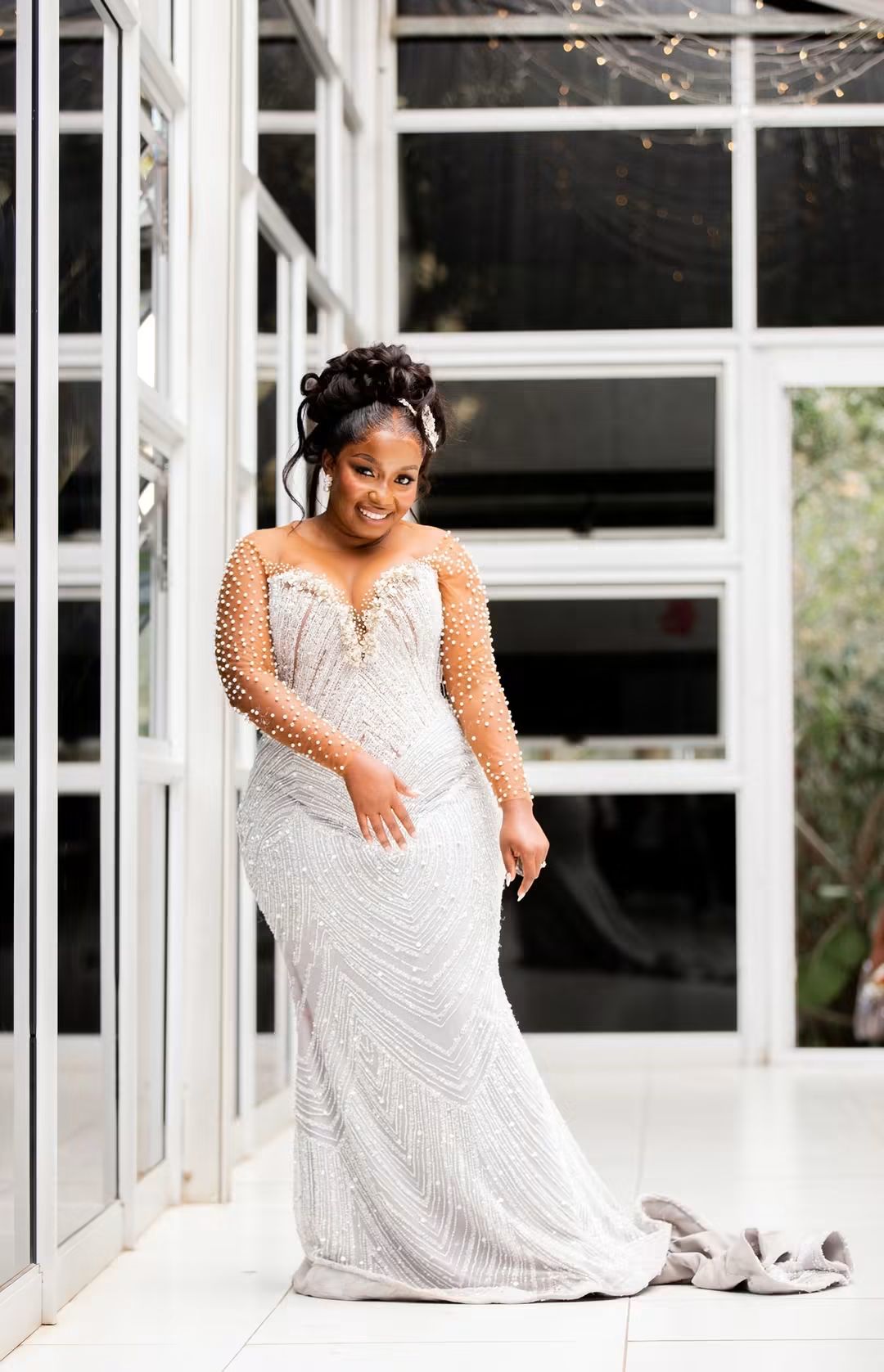 Nyasha in her pearl-beaded wedding gown in the glasshouse at her Harare wedding