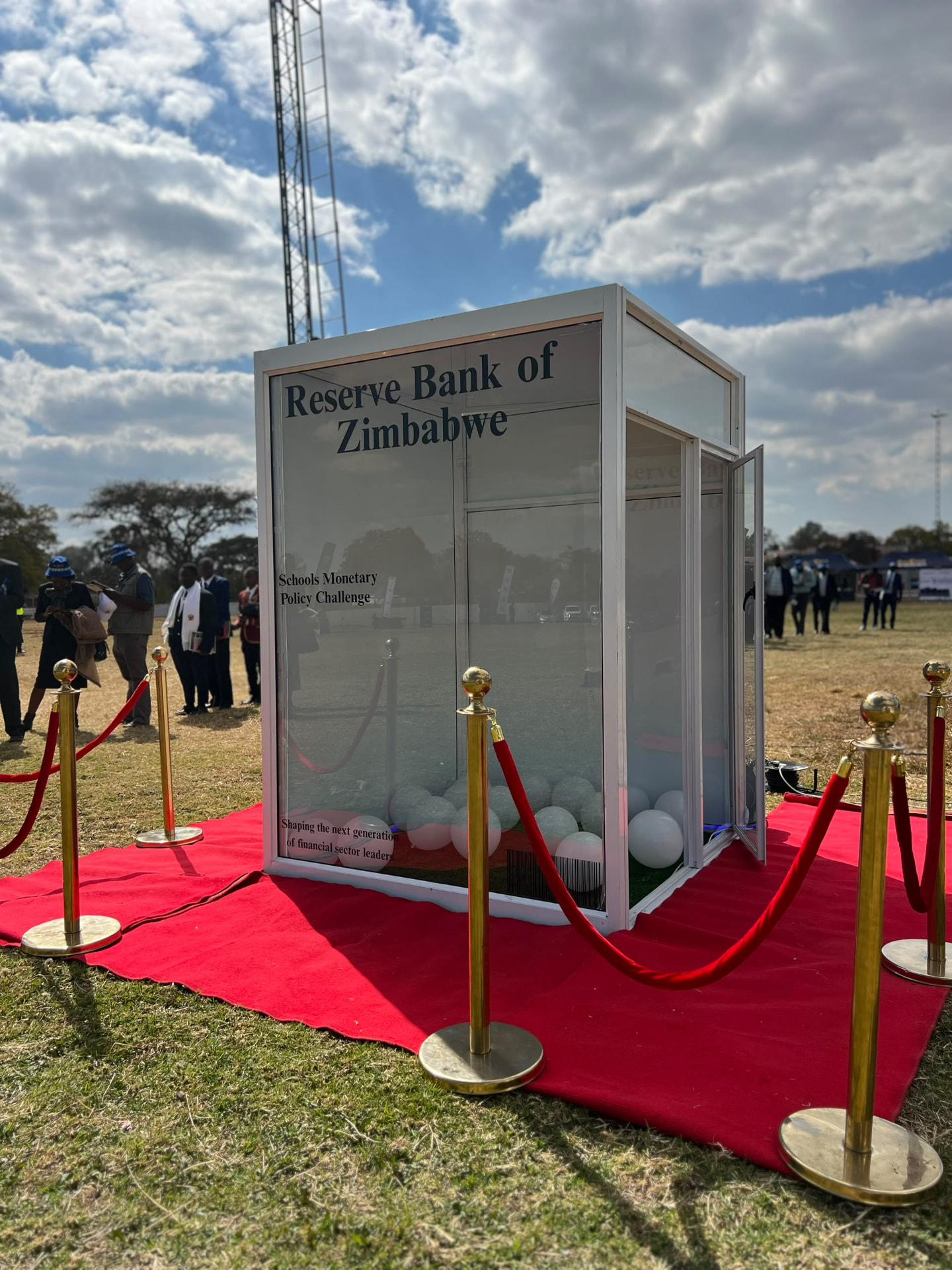 White magazine-cover photo booth on a red carpet with gold stanchions