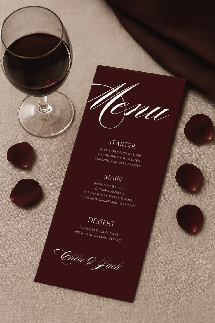 Burgundy wedding menu card styled with rose petals