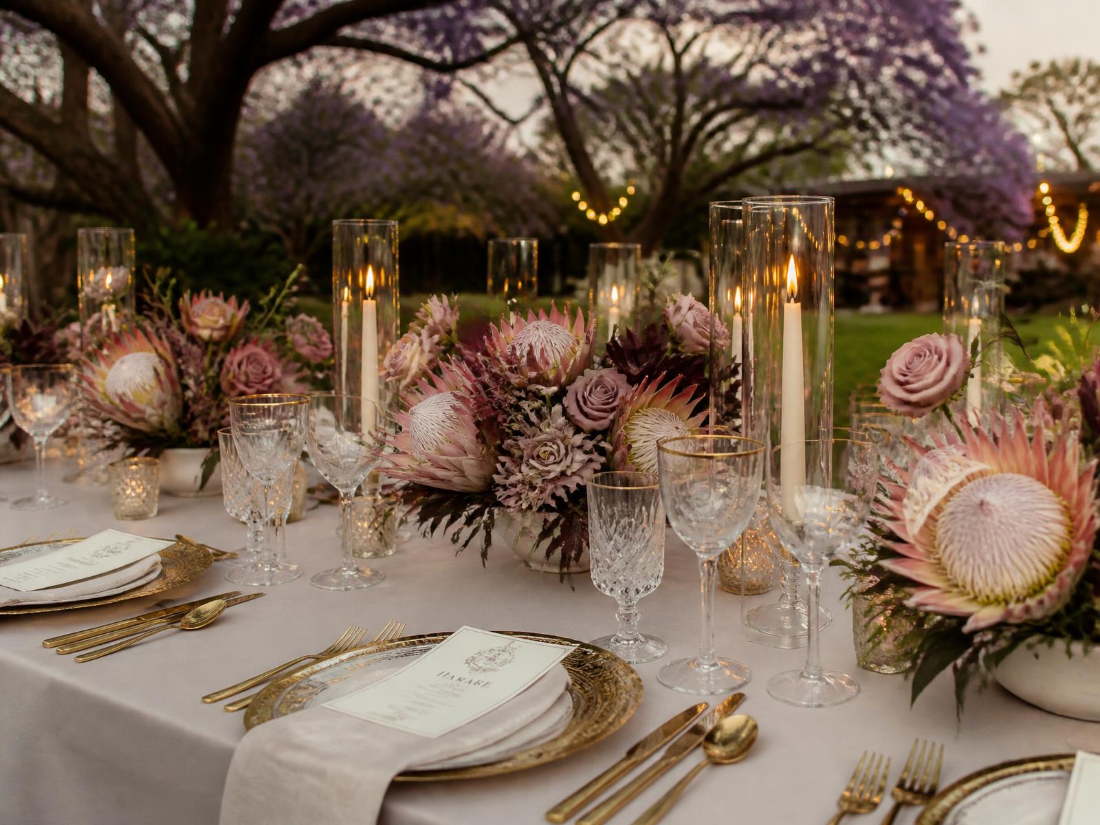 Luxurious candlelit table setting at a Caronai event