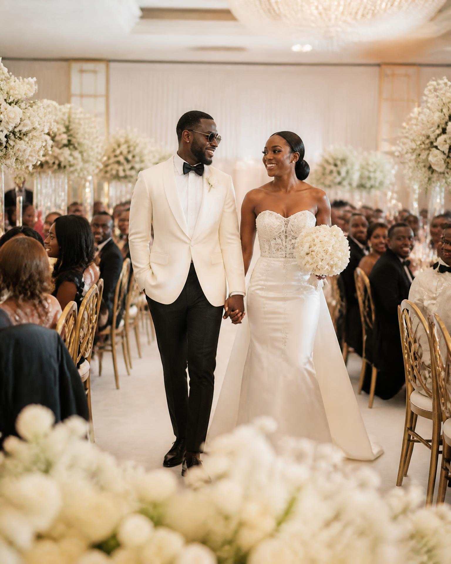 Ceremony aisle styled with white florals and draped seating
